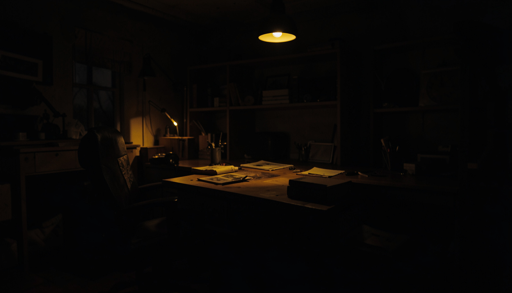 A dark, low-key photograph of a quiet study or workshop interior with deep shadows, warm wood tones, and soft ambient light suggesting a personal creative space.